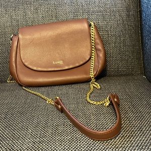 Lipault leather handbag with chain accent strap.